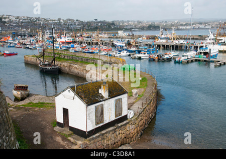 VIew of Newlyn old harbour with restored Cornish sailing Lugger 'Ripple' and fishing port behind, Cornwall UK Stock Photo