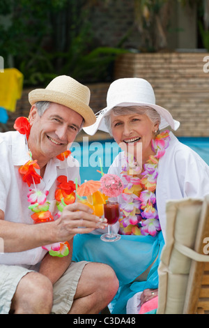 Happy senior couple drinking cocktail and toasting each other Stock Photo