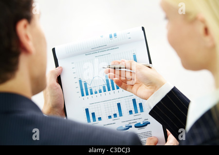 Image of paper being discussed by two business partners Stock Photo