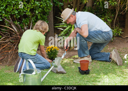 Grandfather with his grandson working in the garden Stock Photo