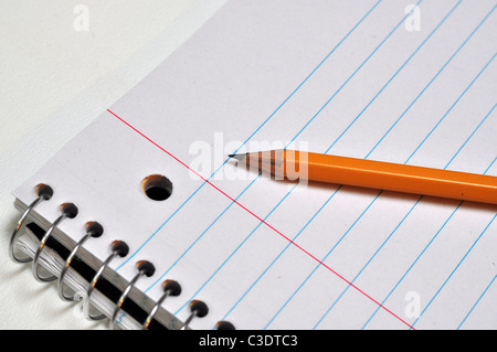 A close up shot of a notebook page with a pencil on it. Stock Photo