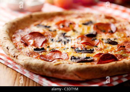 pepperoni and mushrooom pizza closeup, shallow dof Stock Photo