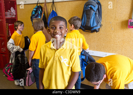 African-American boy wearing school uniform shirt smiles in hallway at Rapoport Academy charter elementary school in Waco Texas Stock Photo