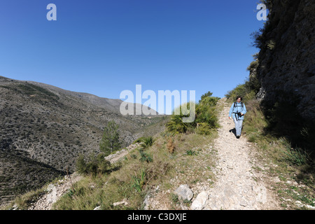 woman hiker on Mozarab trail, near Benimaurell, Vall de Laguart, Alicante Province,Valencia, Spain Stock Photo