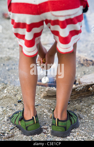 boy roasting marshmallow over fire Stock Photo