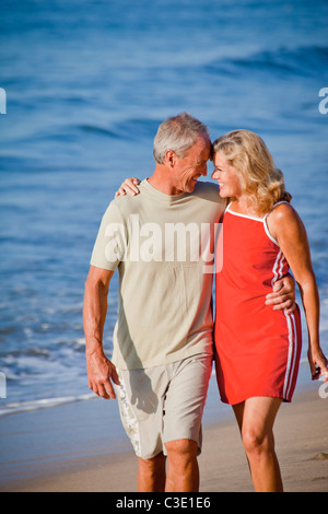 middle aged couple hugging on beach Stock Photo