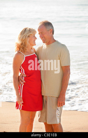 middle aged couple hugging on beach Stock Photo