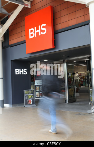 Shop sign with blurred pedestrian Stock Photo