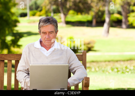 Senior man working on his laptop Stock Photo