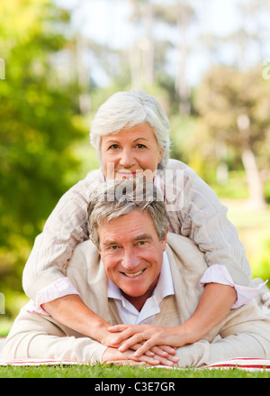 Mature couple lying down in the park