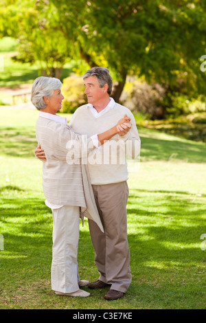 Senior couple dancing in the park Stock Photo