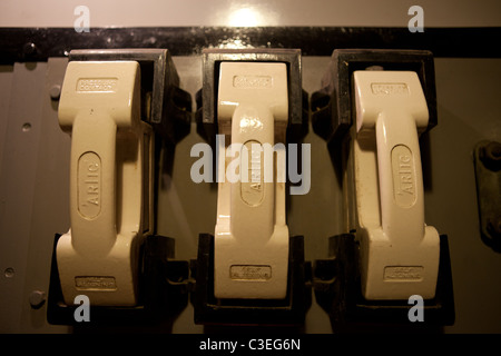 Old style ceramic fuses on a distribution board Stock Photo