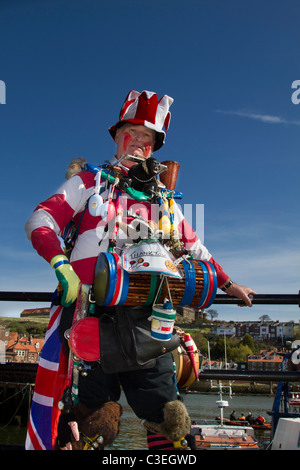 Quirky Oddball, Eccentric Street Musician, Busker & travelling entertainer. Victorian one man band playing drums in fancy dress, Whitby UK Stock Photo