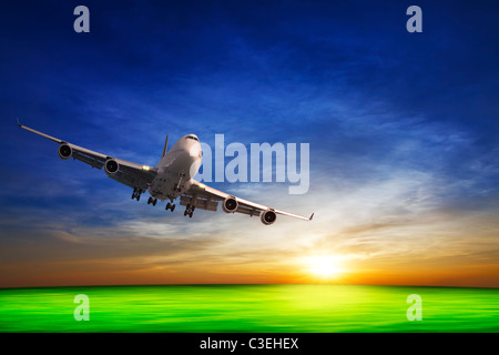 Jet in flight and sunset sky Stock Photo
