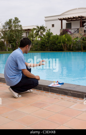 Service man checking , PH and other chemical levels in pool Stock Photo