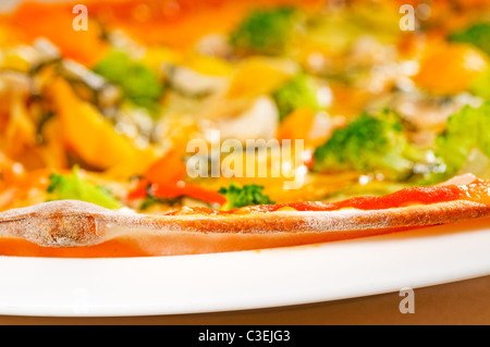 fresh italian thin style vegetarian pizza with fresh mixed vegetables close up Stock Photo