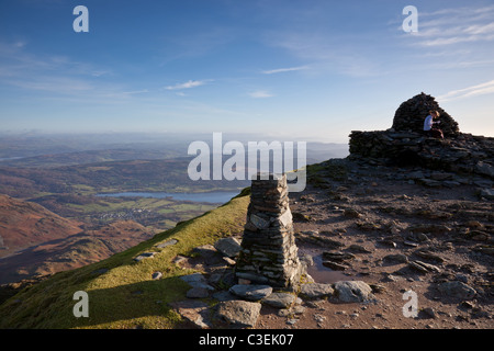 Lone walker on the summit of the Old Man of Coniston, Lake District, Cumbria Stock Photo