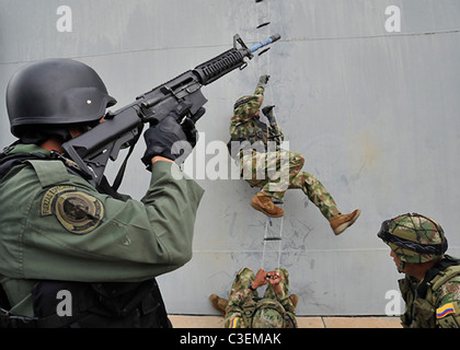 US Navy SEAL team members train boarding a ship in combat simulation with counterparts from Latin America during exercises. Stock Photo