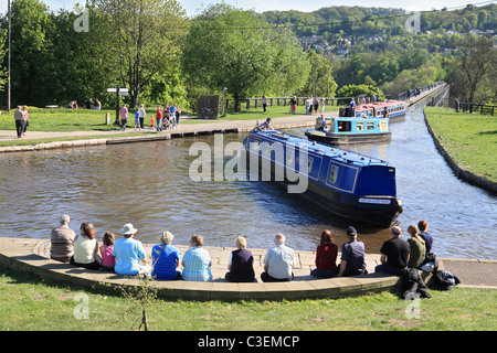 People watching canal boats crossing Pontcysyllte Aqueduct then entering Trefor Basin on the  Llangollen Canal, North Wales, UK