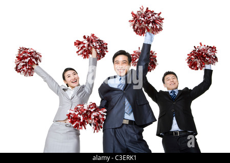 A team of businesspeople cheering with pompoms Stock Photo