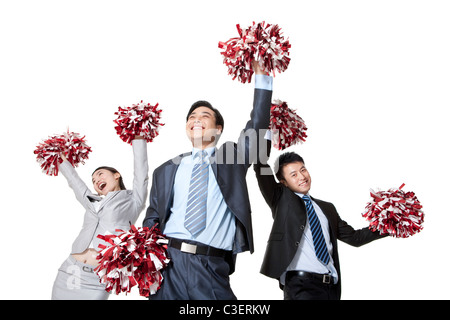 A team of businesspeople cheering with pompoms Stock Photo