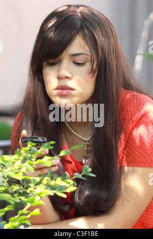 America Ferrera  checks her cell phone during a break from filming her television show 'Ugly Betty' in Manhattan New York City, Stock Photo
