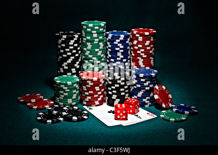 stacks of chips for poker with pair of aces and dice Stock Photo