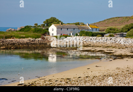 Row of cottages at the end of Great Par beach on Bryher in the Isles of Scilly Stock Photo