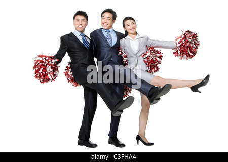 A team of businesspeople cheering with pompoms Stock Photo