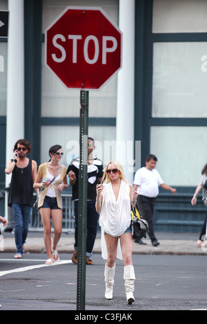 Lindsay Lohan out shopping in SoHo wearing very short shorts and white knee-high boots. Lindsay was out with her sister Ali Stock Photo