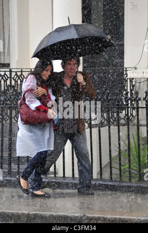 Freida Pinto and Josh Brolin filming a scene in artificial rain on the set of the 'Untitled Woody Allen London Project' London, Stock Photo