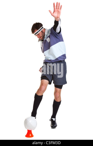 Photo of a rugby player kicking the ball off a tee, cut out on a white background. Stock Photo