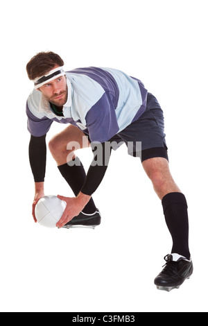 Photo of a rugby player passing the ball, cut out on a white background. Stock Photo