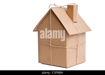 Photo of a wrapped house in brown recycled paper, cut out on a white background. Stock Photo