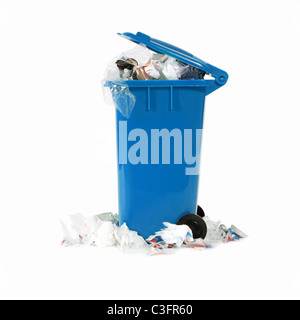 overflowing blue garbage bin Stock Photo