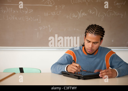 Peruvian student studying in classroom on laptop Stock Photo