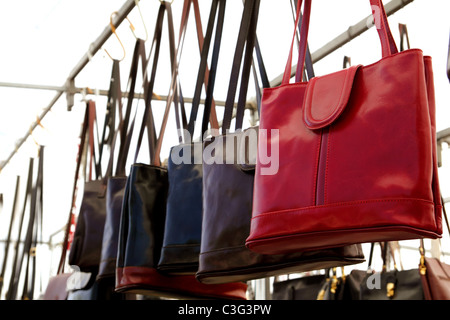 bags rows in retail shop handbags leather red in foreground Stock Photo