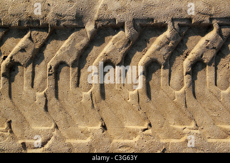 tractor tires pneus footprint printed on beach sand desert Stock Photo