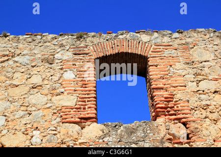 brick segmental arch in ancient masonry stone wall Spain Stock Photo