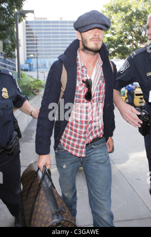 David Beckham, carrying his Louis Vuitton travel bag, gets a police escort  as he arrives at LAX airport on a British Airways Stock Photo - Alamy