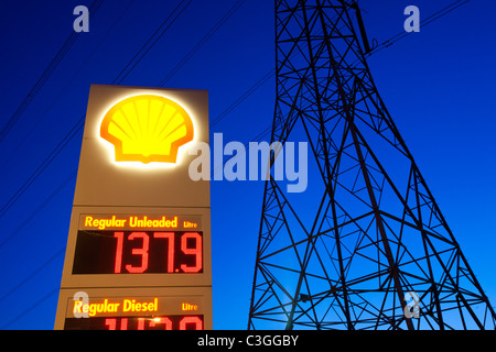 A petrol station in Billingham on Teeside, UK, with an electricity pylon at dusk. Stock Photo