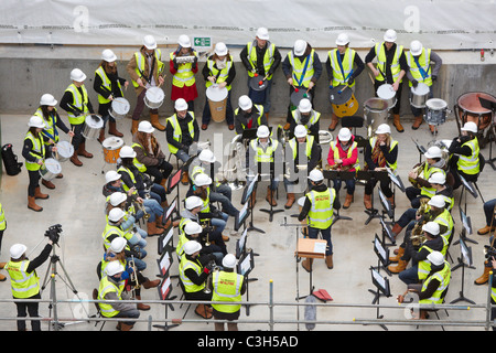 Guildhall School of Music and Drama students perform a 'hard hat prom' on the construction site of their new concert hall. Stock Photo