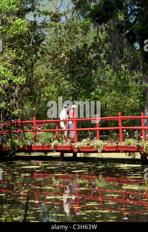 South Carolina, Charleston, Magnolia Plantation & Gardens. Red garden bridge. Stock Photo