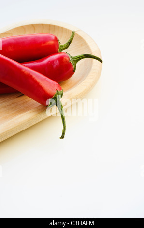 Close up of chili peppers on wooden tray Stock Photo