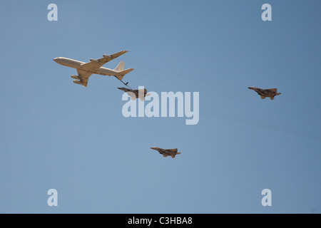 Israeli Air force Boeing 707 refueling F15i fighter jet as two more jets secure the maneuver - part of Independence Day display Stock Photo