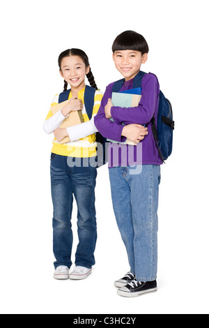 Two students standing and holding their books Stock Photo
