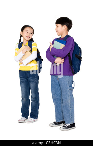 Two students standing and holding their books Stock Photo