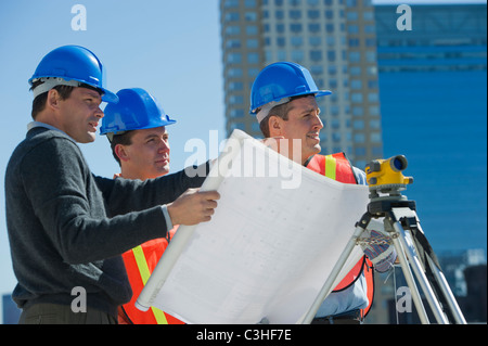 Construction workers reading blueprint Stock Photo