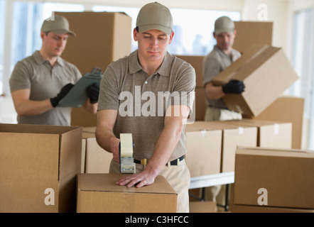 Men packing boxes in warehouse Stock Photo