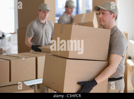 Men sorting boxes in warehouse Stock Photo